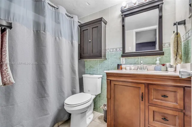 a bathroom with a sink toilet and mirror