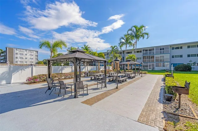 a view of a swimming pool with outdoor seating