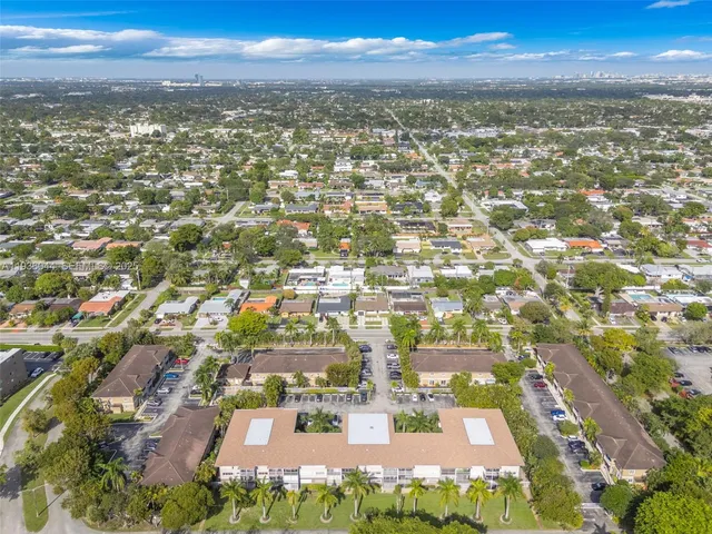 an aerial view of residential building with green space