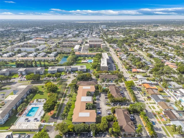 an aerial view of residential building with green space