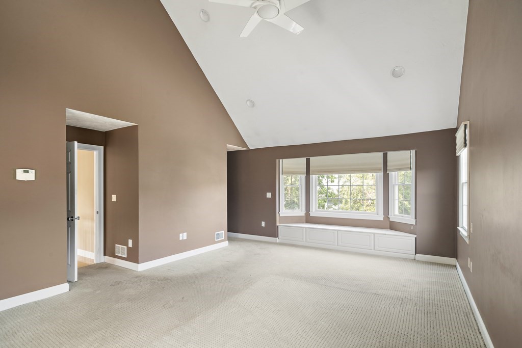 33 Bridge Street Needham, MA 02494 - Photo 13 of 19 an empty room with windows and a ceiling fan