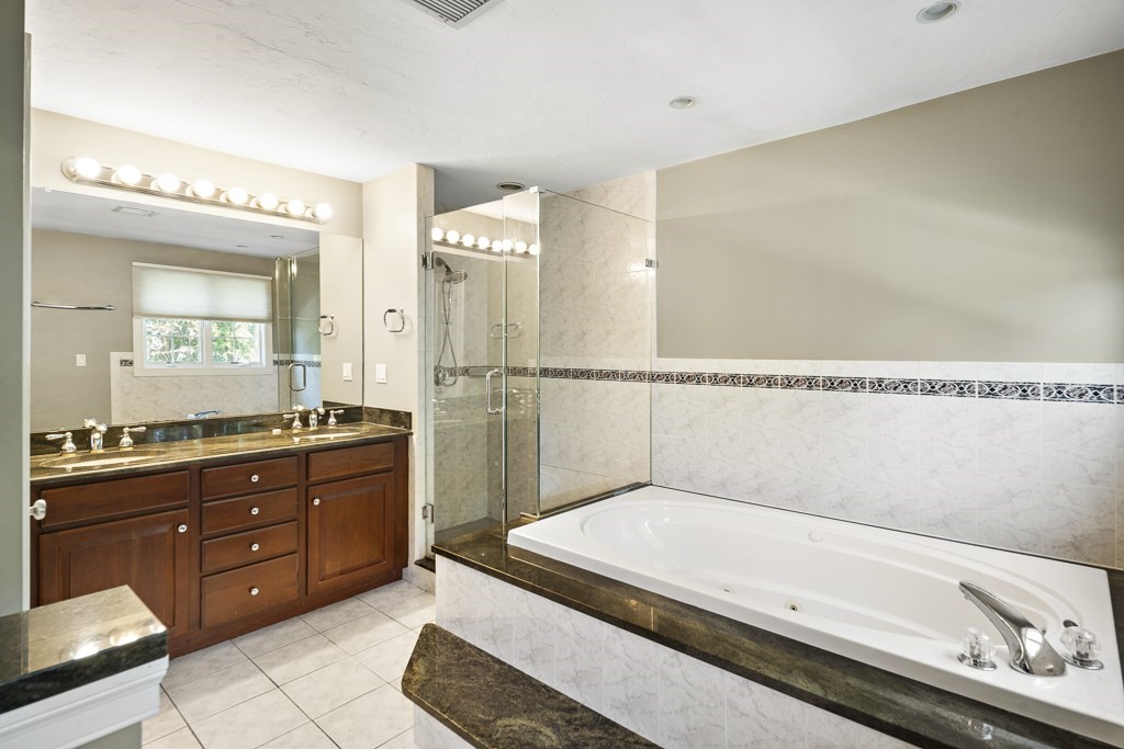 33 Bridge Street Needham, MA 02494 - Photo 14 of 19 a spacious bathroom with a granite countertop sink and a mirror