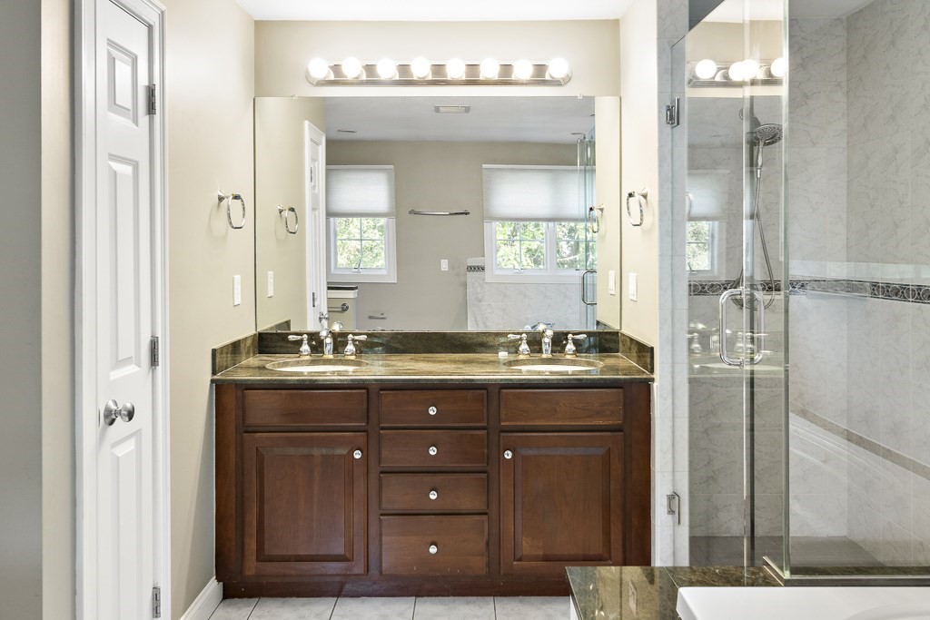 33 Bridge Street Needham, MA 02494 - Photo 15 of 19 a bathroom with a granite countertop sink a mirror and a shower