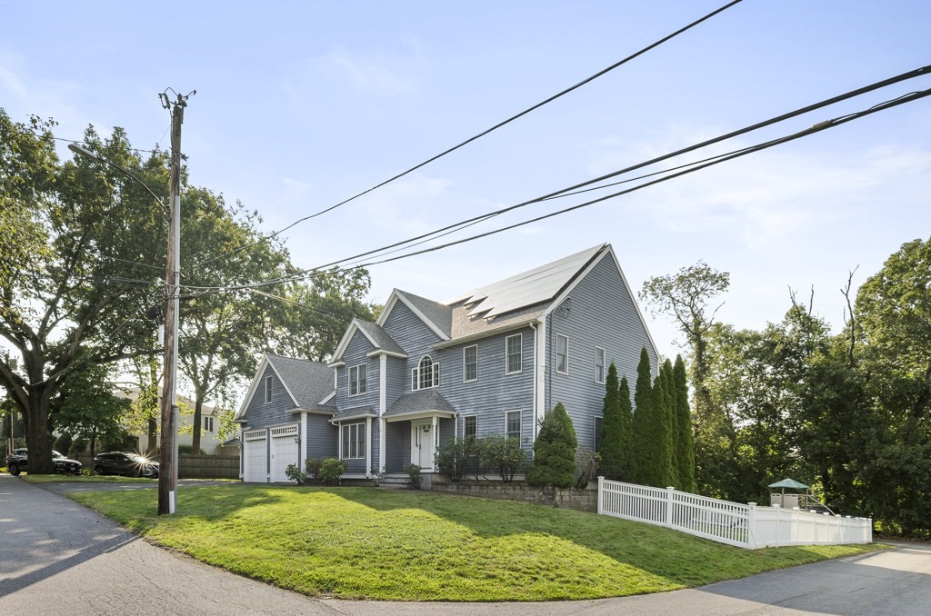 33 Bridge Street Needham, MA 02494 - Photo 16 of 19 a view of a white house next to a yard with big trees