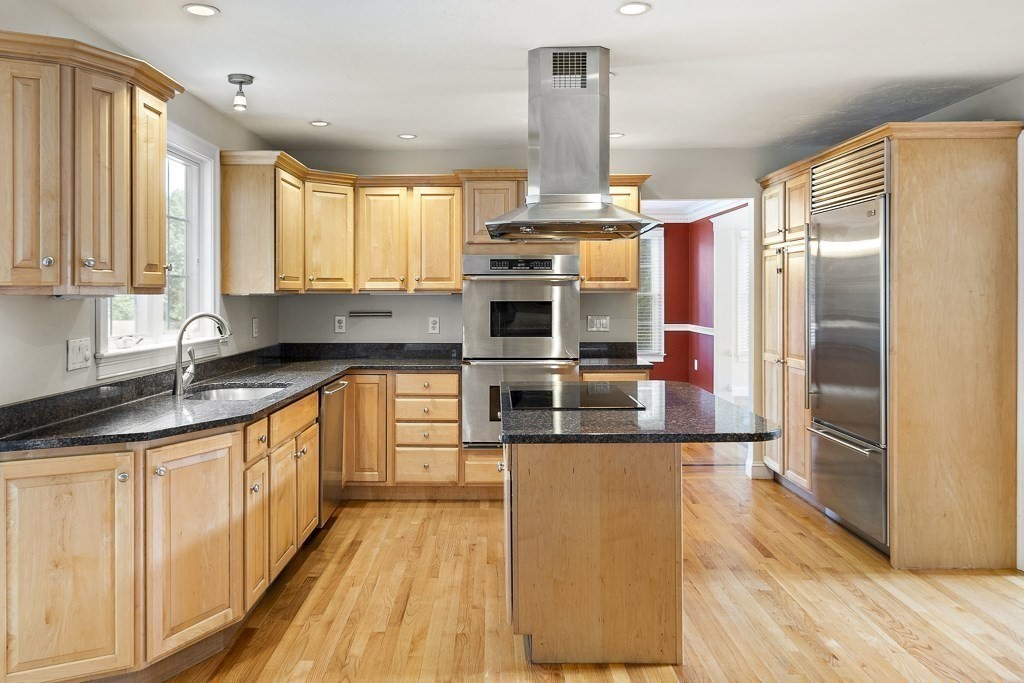 33 Bridge Street Needham, MA 02494 - Photo 2 of 19 a kitchen with stainless steel appliances a sink and a refrigerator
