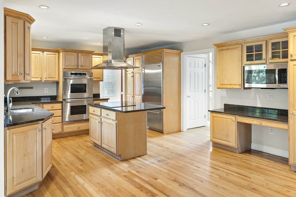 33 Bridge Street Needham, MA 02494 - Photo 3 of 19 a kitchen with stainless steel appliances a stove top oven and a refrigerator