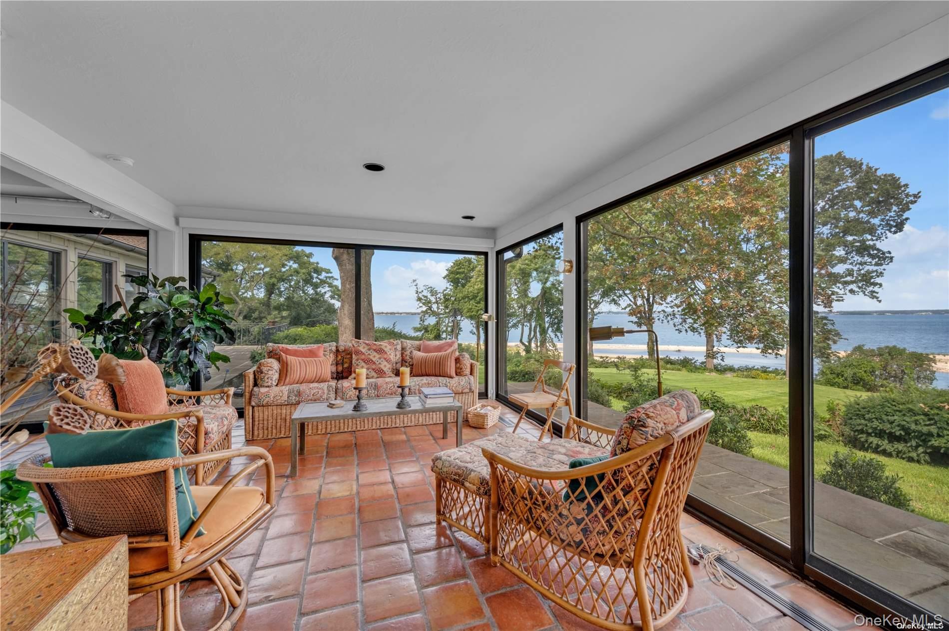 120 West Creek Farms Road Sands Point, NY 11050 - Photo 12 of 36 a living room with patio furniture and a floor to ceiling window