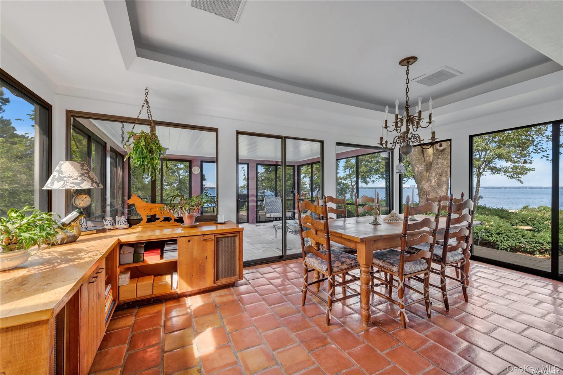 120 West Creek Farms Road Sands Point, NY 11050 - Photo 14 of 36 a view of a dining room with furniture wooden floor and chandelier