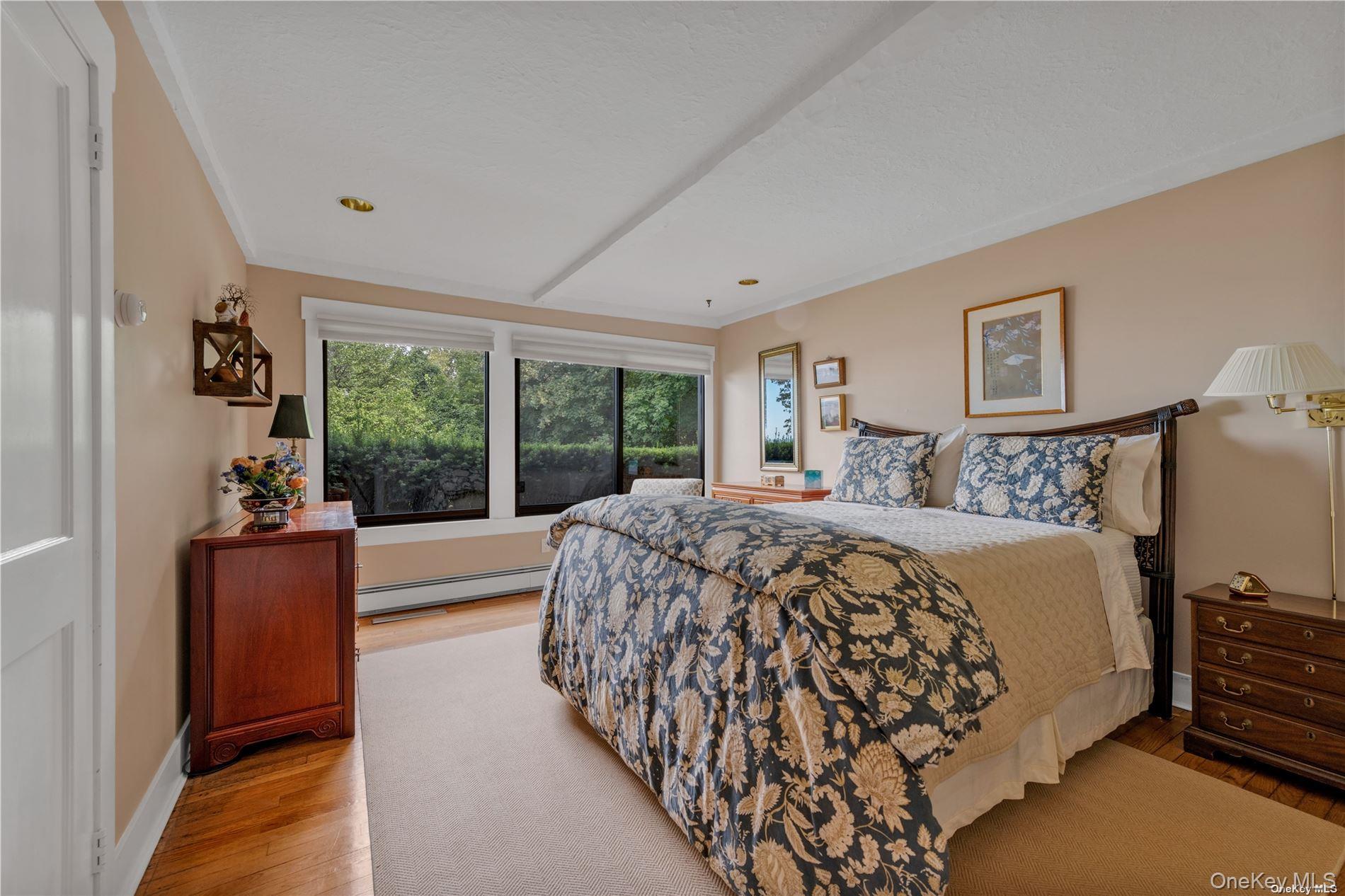 120 West Creek Farms Road Sands Point, NY 11050 - Photo 17 of 36 a bed sitting in a bedroom next to a window