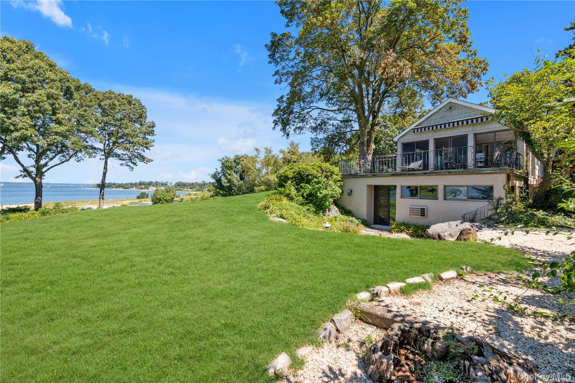 120 West Creek Farms Road Sands Point, NY 11050 - Photo 26 of 36 a front view of a house with a garden