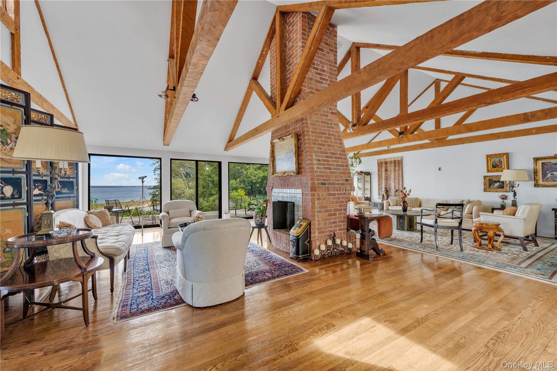 120 West Creek Farms Road Sands Point, NY 11050 - Photo 7 of 36 a living room with furniture a wooden floor and a large window