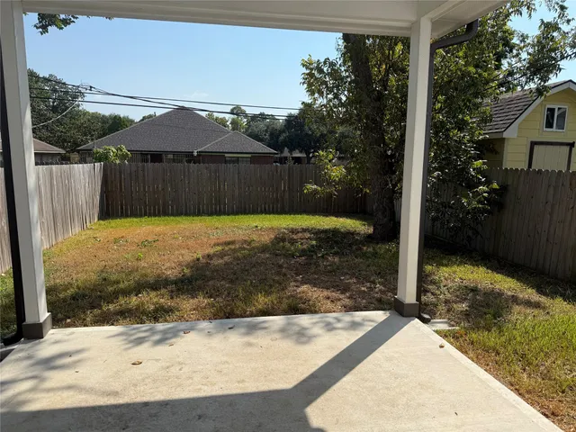 a view of a house with a small backyard