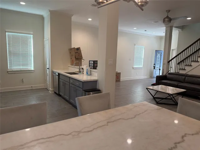 a living room with furniture and a piano
