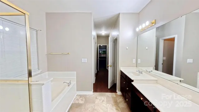 a bathroom with a double vanity sink a mirror and a shower