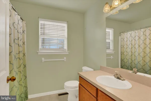 a bathroom with a sink toilet and a mirror
