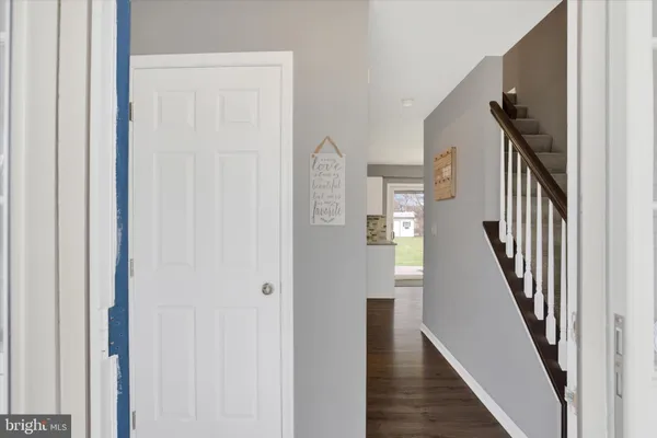 a view of entryway and hall with wooden floor