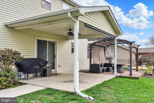 a view of a house with a yard and furniture
