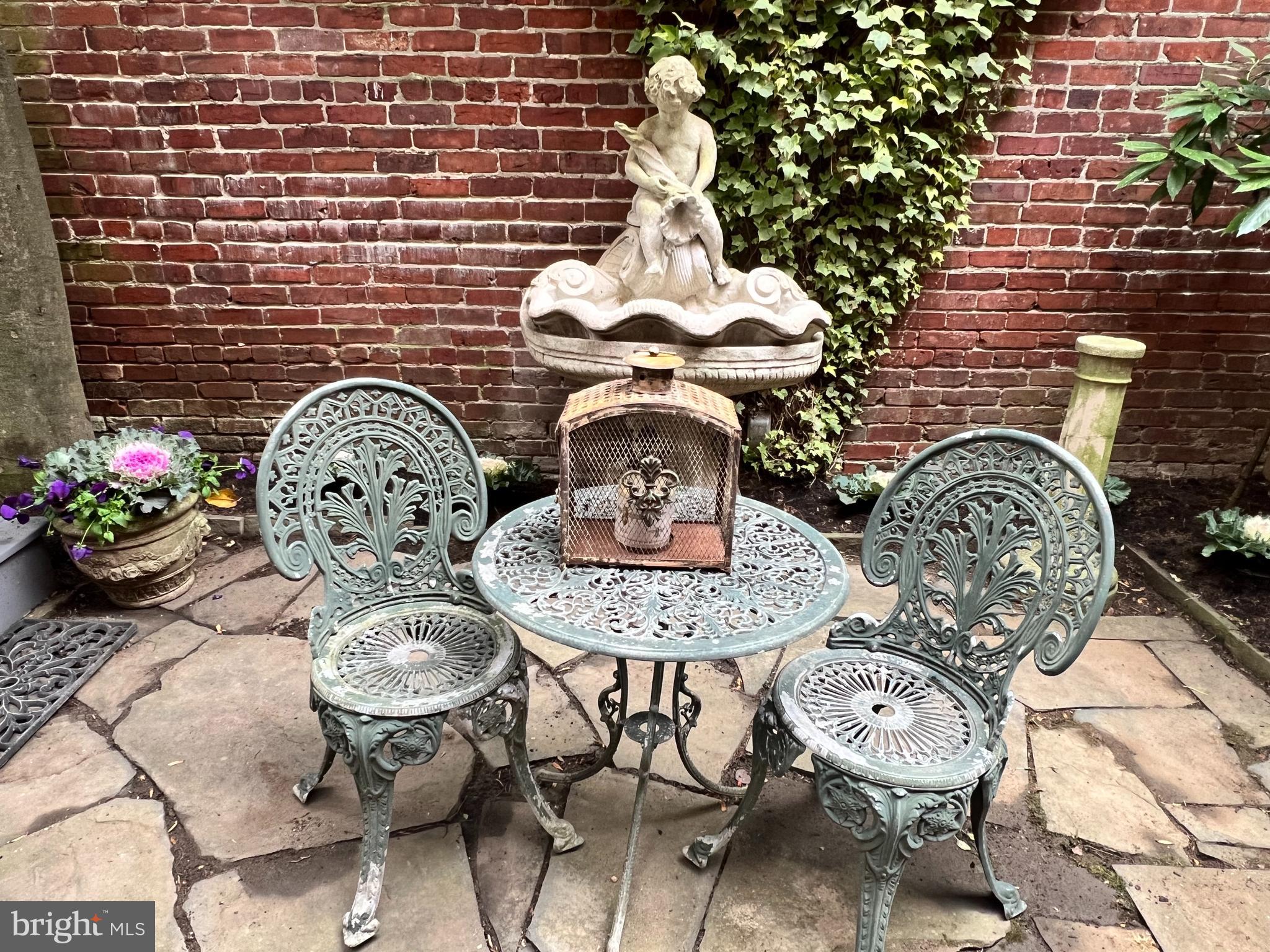 3070 Q Street Northwest Washington, DC 20007 - Photo 16 of 33 a vase of flowers sitting on a table in a patio