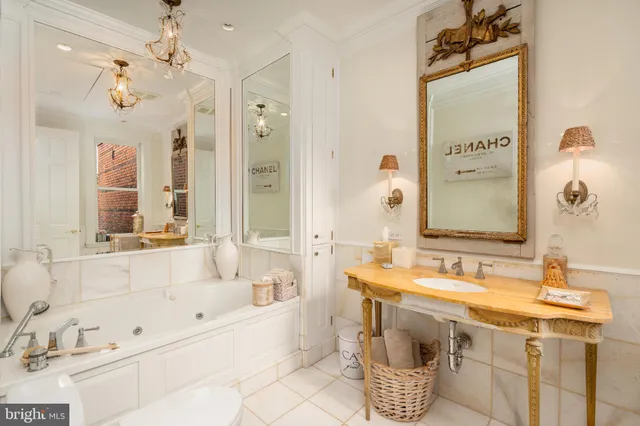 a bathroom with a tub sink and mirror