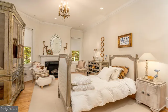 a living room with furniture a fireplace and a chandelier