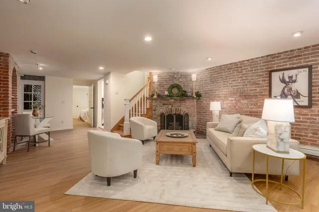 a living room with fireplace furniture and a wooden floor