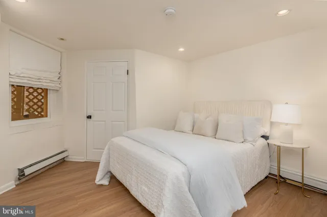 a bedroom with a bed and a night stand