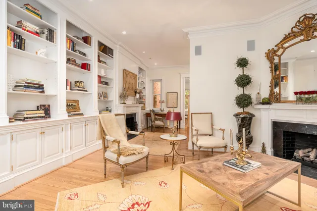 a living room with furniture a fireplace and decor