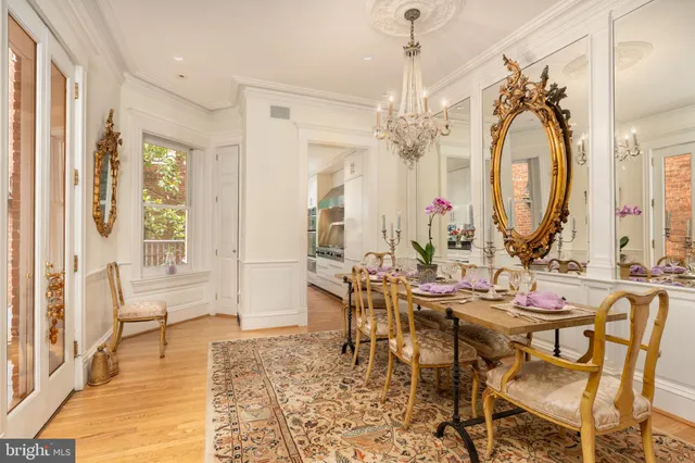 a view of a dining room with furniture and a chandelier