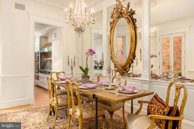 a view of a dining room with furniture and a chandelier