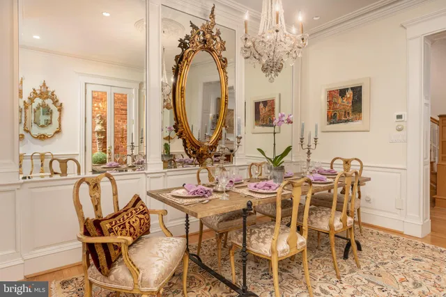 a view of a dining room with furniture and a chandelier