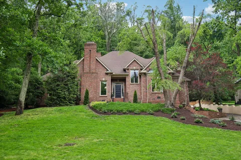 a view of a house with a yard and sitting area