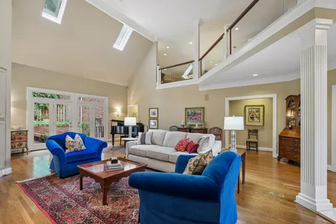 a living room with furniture a fireplace and a large window