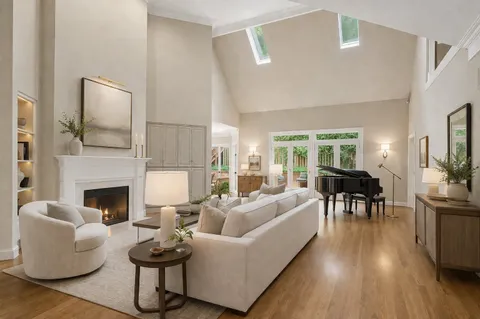 a living room with furniture a rug and a table