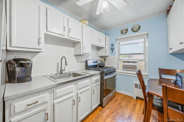 a kitchen with stainless steel appliances granite countertop a sink stove and cabinets
