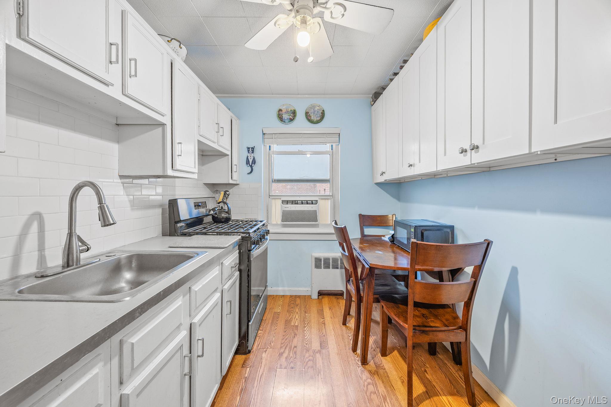 470 Tuckahoe Road, Unit 2A Yonkers, NY 10710 - Photo 7 of 12 a kitchen with stainless steel appliances granite countertop a sink and cabinets