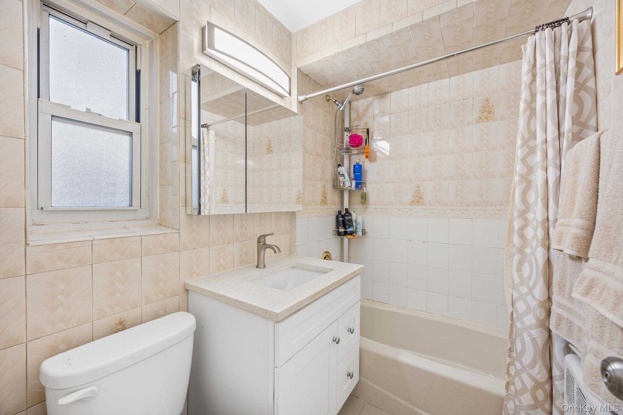 470 Tuckahoe Road, Unit 2A Yonkers, NY 10710 - Photo 10 of 12 a bathroom with a sink toilet and shower