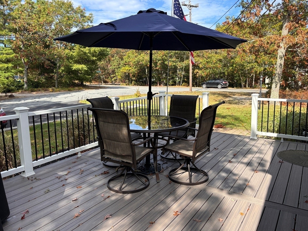 112 Clay Pond Road Bourne, MA 02532 - Photo 27 of 39 a view of a chair and table on the wooden floor