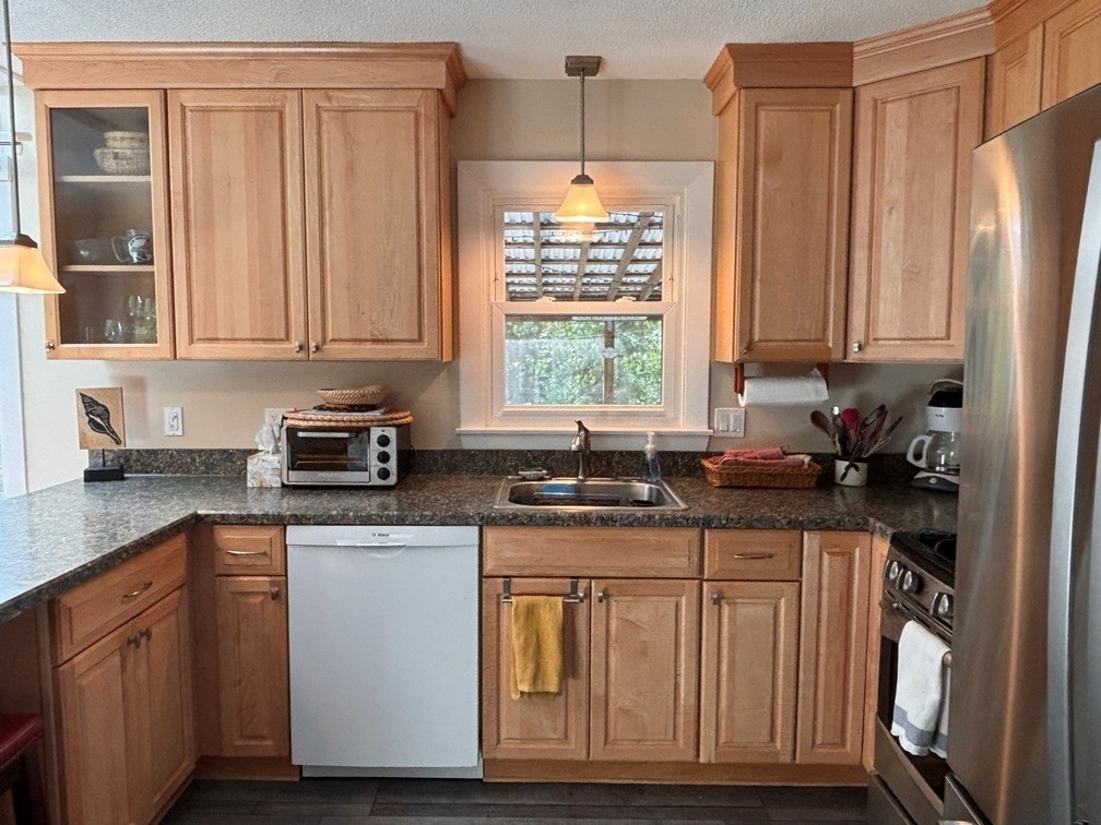 112 Clay Pond Road Bourne, MA 02532 - Photo 3 of 39 a kitchen with stainless steel appliances granite countertop a stove a sink dishwasher and cabinets with wooden floor
