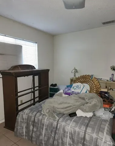 a bedroom with a bed and a window