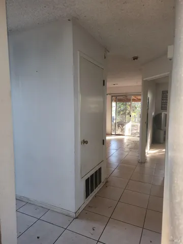 a view of a hallway with wooden shelves