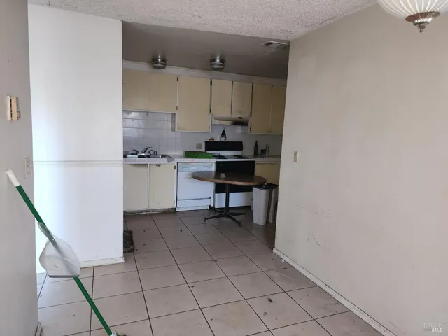 a kitchen with a sink a stove and a refrigerator