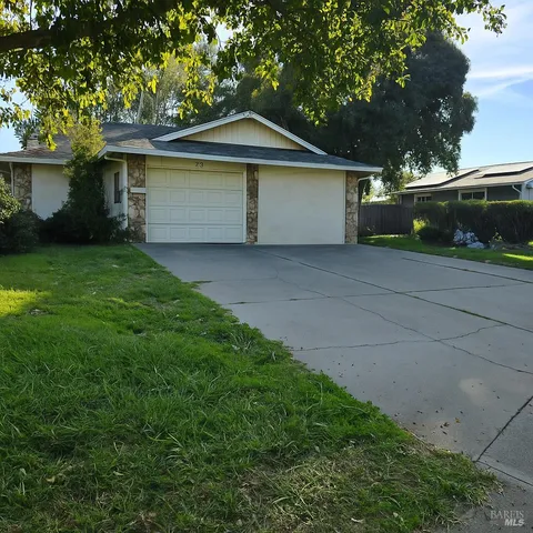 a front view of a house with a garden and garage