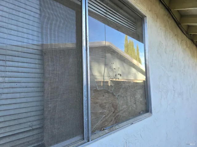 a room with patio furniture and a floor to ceiling window