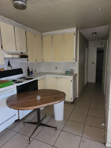 a kitchen with a sink a counter and cabinets
