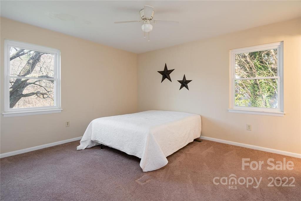 2 Eastcrest Drive Fairview, NC 28730 - Photo 17 of 32 a spacious bedroom with a bed and a window