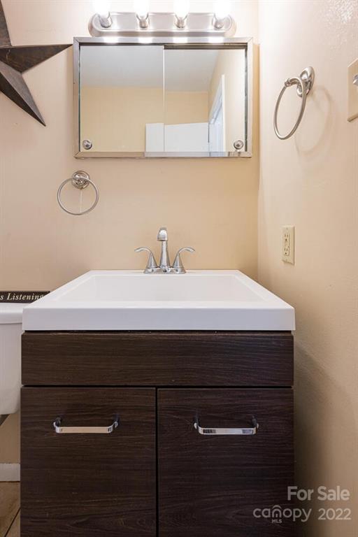 2 Eastcrest Drive Fairview, NC 28730 - Photo 24 of 32 a bathroom with a sink a vanity and a mirror