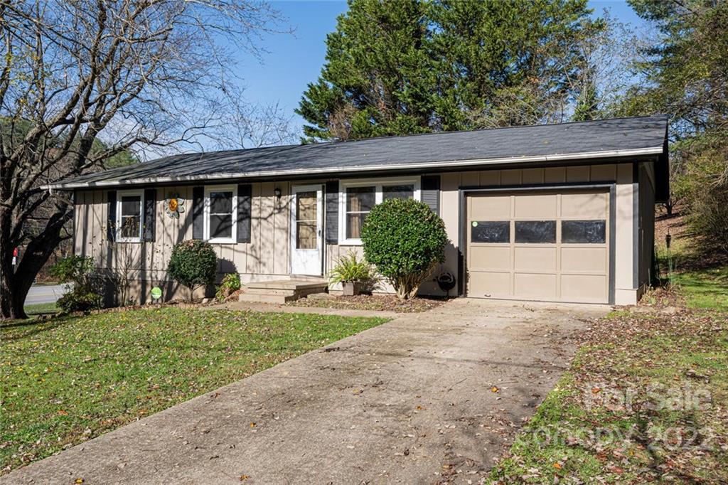 2 Eastcrest Drive Fairview, NC 28730 - Photo 3 of 32 a front view of a house with a yard and potted plants
