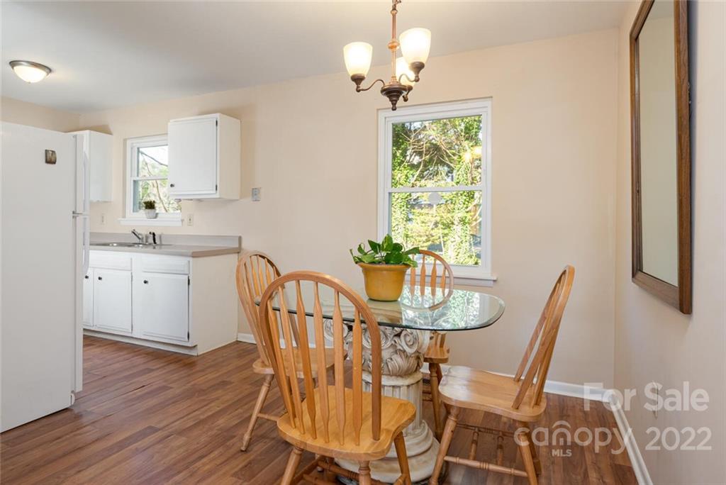 2 Eastcrest Drive Fairview, NC 28730 - Photo 9 of 32 a dining room with furniture a chandelier and wooden floor