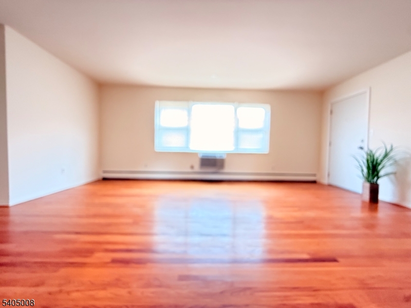 12 Rustic Circle Montvale, NJ 07645 - Photo 3 of 13 an empty room with wooden floor and windows