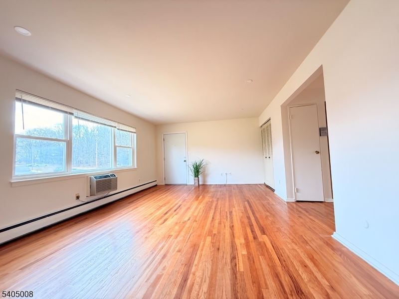 12 Rustic Circle Montvale, NJ 07645 - Photo 4 of 13 an empty room with wooden floor and windows